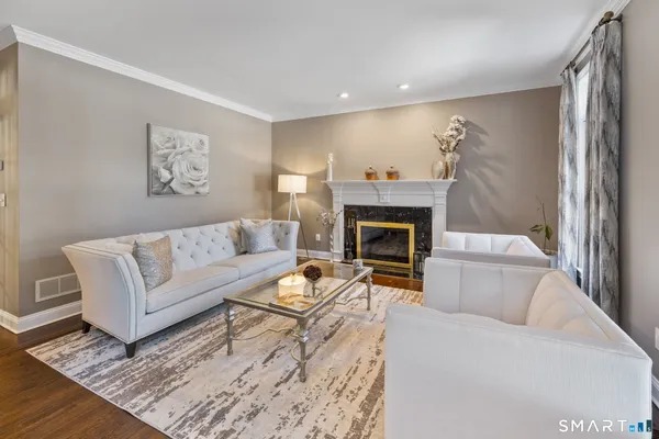 a living room with furniture and a fireplace