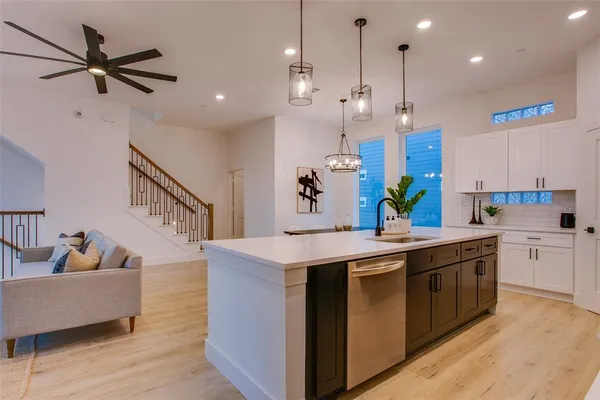 a kitchen with a sink a counter top space and stainless steel appliances