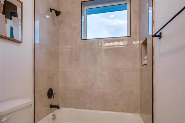 a bathroom with a bathtub and shower