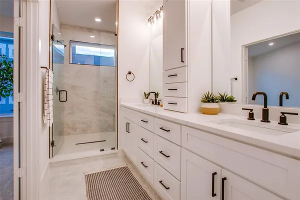 a bathroom with a shower sink and mirror