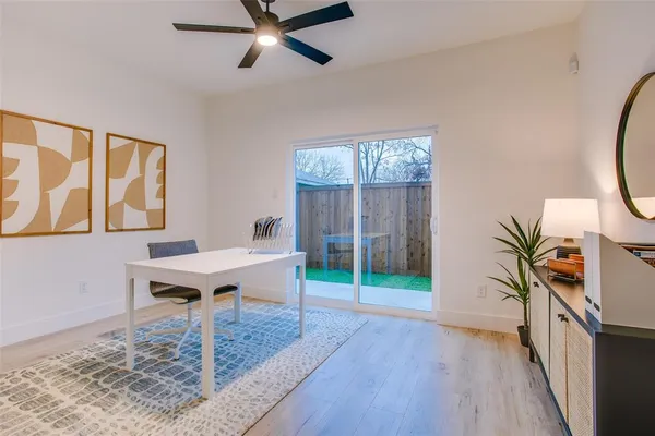 a view of a livingroom with wooden floor and front door