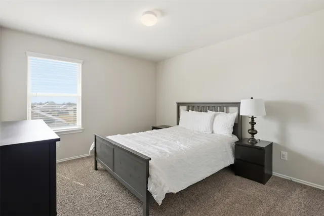 a bedroom with a bed and window