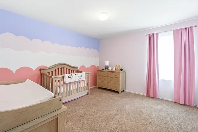 a bedroom with furniture and a window