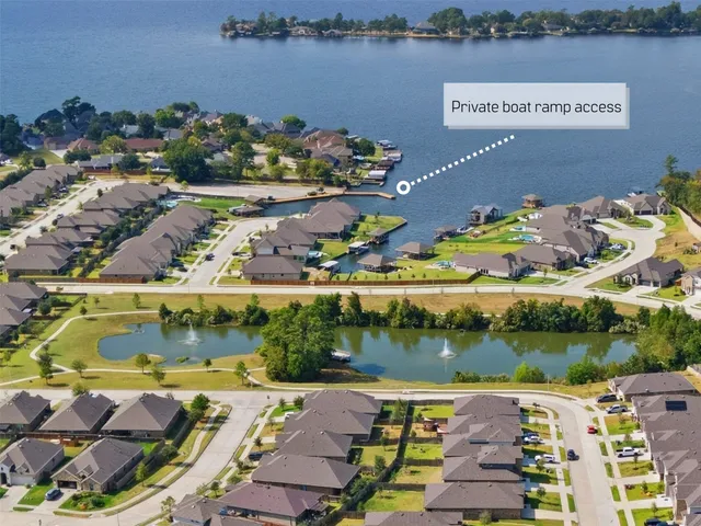 an aerial view of a house with a lake view