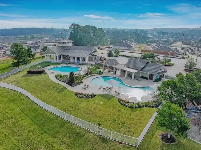 an aerial view of a house with a garden and lake view
