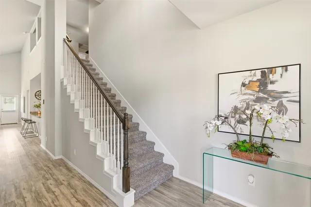 a view of entryway and hall with wooden floor