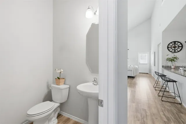 a bathroom with a toilet a sink and a mirror