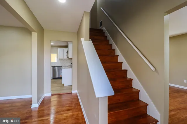 a large kitchen with stainless steel appliances granite countertop a stove a sink and a refrigerator