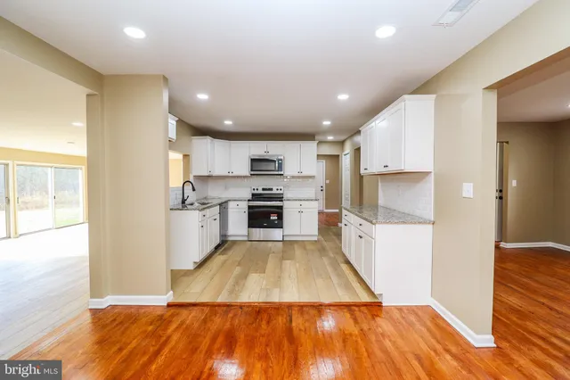 wooden floor in an empty room with a fireplace