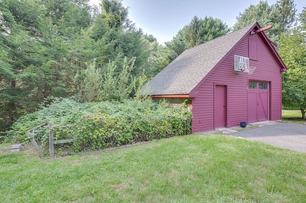 73 Weston Road Lincoln, MA 01773 - Photo 28 of 30 a view of a back yard with a small cabin