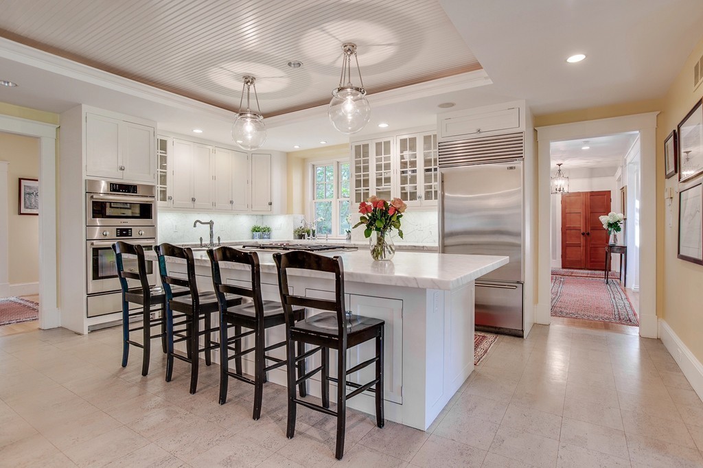 73 Weston Road Lincoln, MA 01773 - Photo 6 of 30 a kitchen with stainless steel appliances kitchen island granite countertop a table chairs and a refrigerator