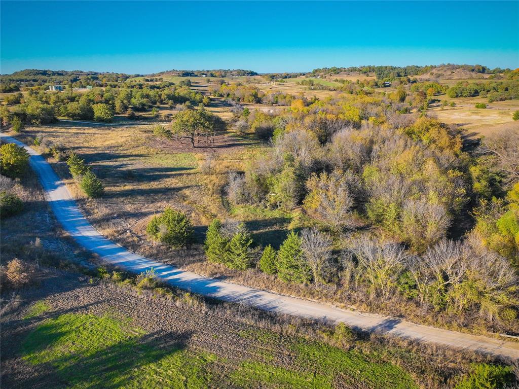 4 Lazy E Road St. Jo, TX 76265 - Photo 5 of 21 a view of a lake with lawn chairs
