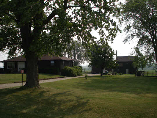 7357 Junction Road Davis Junction, IL 61020 - Photo 1 of 6 a view of a tree in front of a house