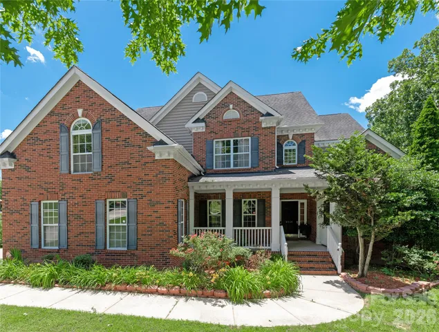 front view of brick house with a yard
