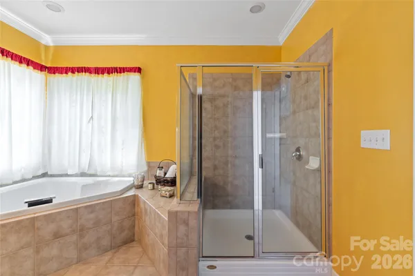 a bathroom with a tub sink and mirror