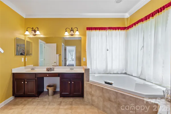 a view of empty room with window and ceiling fan