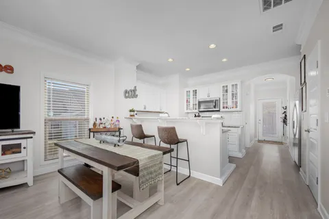 a kitchen with kitchen island white cabinets and stainless steel appliances