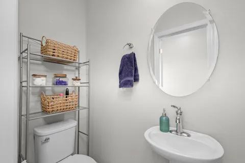 a bathroom with a toilet a sink and a mirror