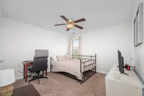 a bedroom with a bed a desk and chair