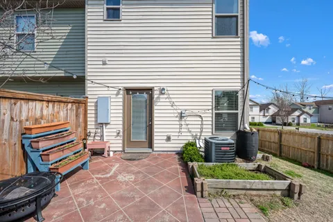 a house view with a backyard and a garden