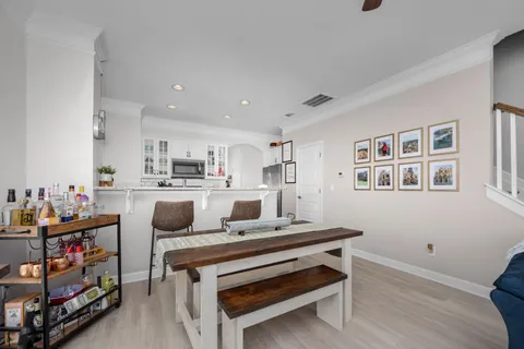 a living room with furniture and a kitchen view