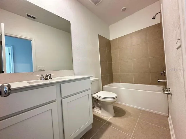 a bathroom with a sink a toilet and a bathtub