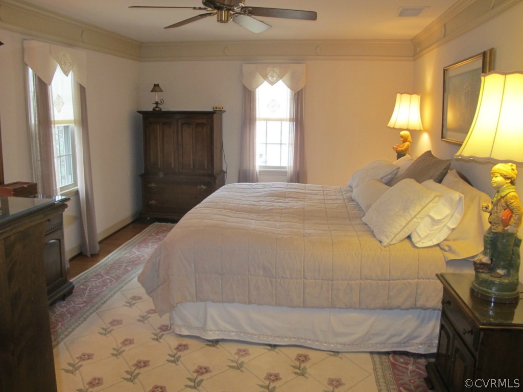 3815 Cresthill Road Chester, VA 23831 - Photo 15 of 24 a spacious bedroom with a bed and a flat tv screen on dresser