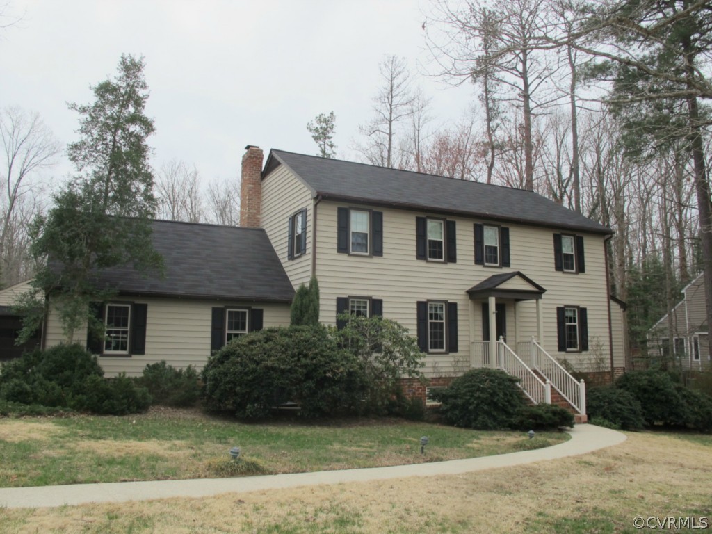 3815 Cresthill Road Chester, VA 23831 - Photo 2 of 24 a front view of a house with a garden