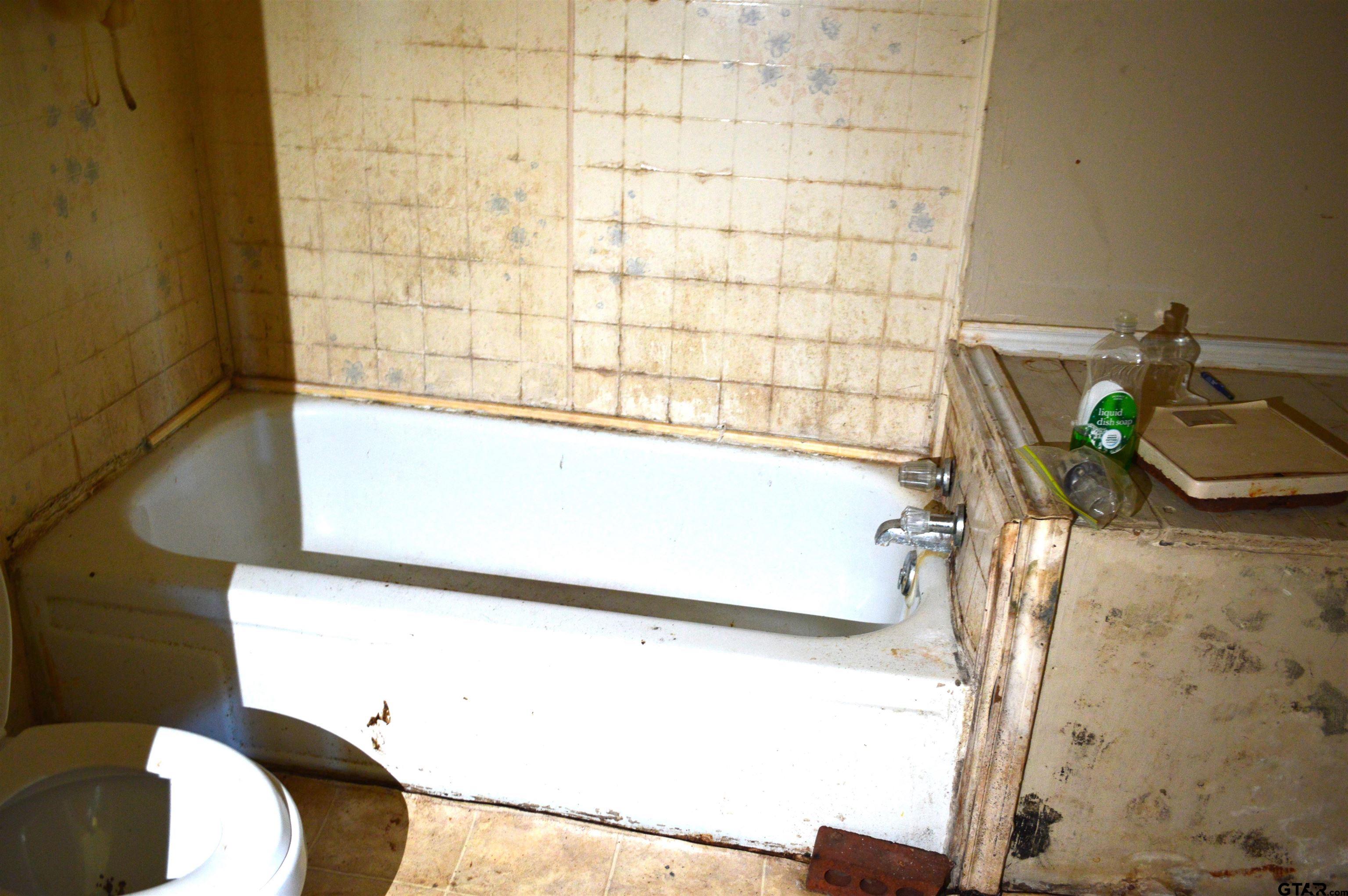 3210 Bellwood Road Tyler, TX 75701 - Photo 13 of 18 a bathroom with a sink and a shower