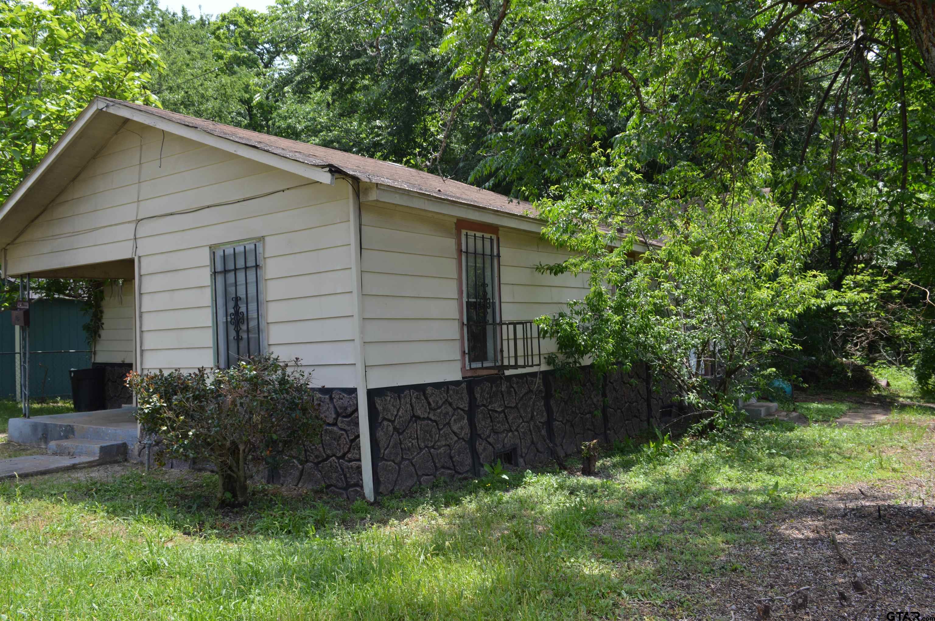 3210 Bellwood Road Tyler, TX 75701 - Photo 17 of 18 a view of a house with a yard and plants
