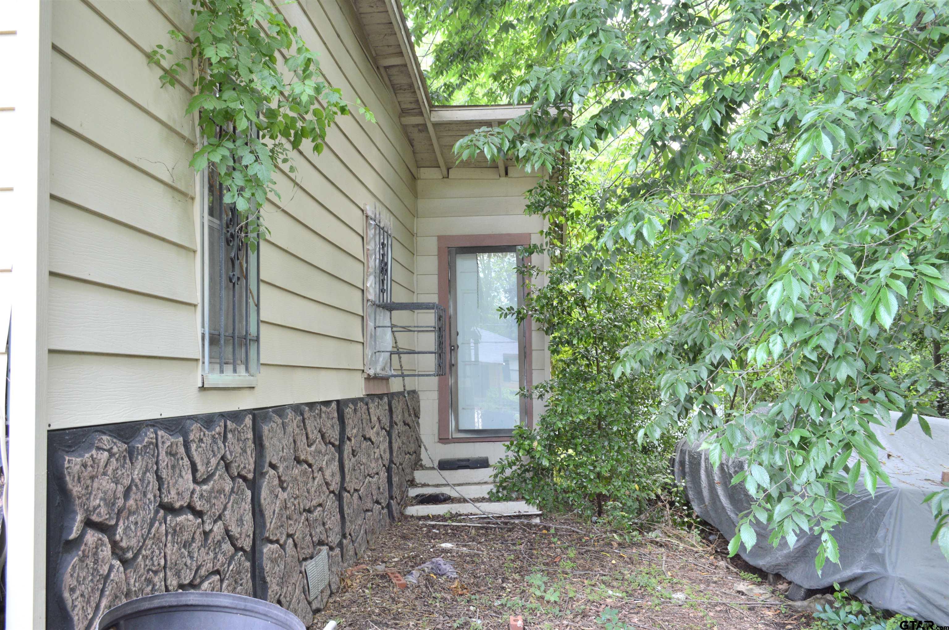 3210 Bellwood Road Tyler, TX 75701 - Photo 5 of 18 a side view of a house with a tree