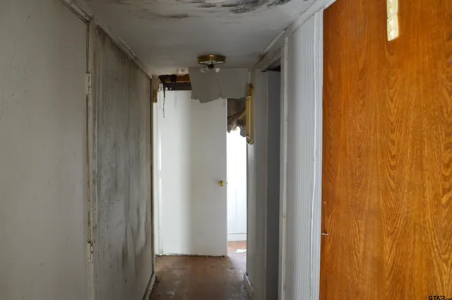 a room with a window and a rug