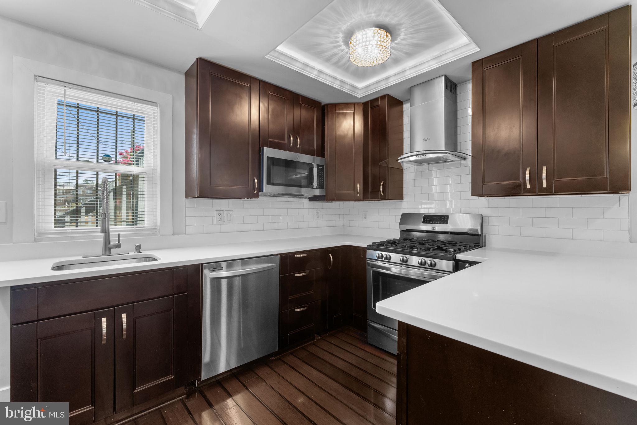 5209 5th Street Northwest Washington, DC 20011 - Photo 12 of 47 a kitchen with a sink stove and cabinets