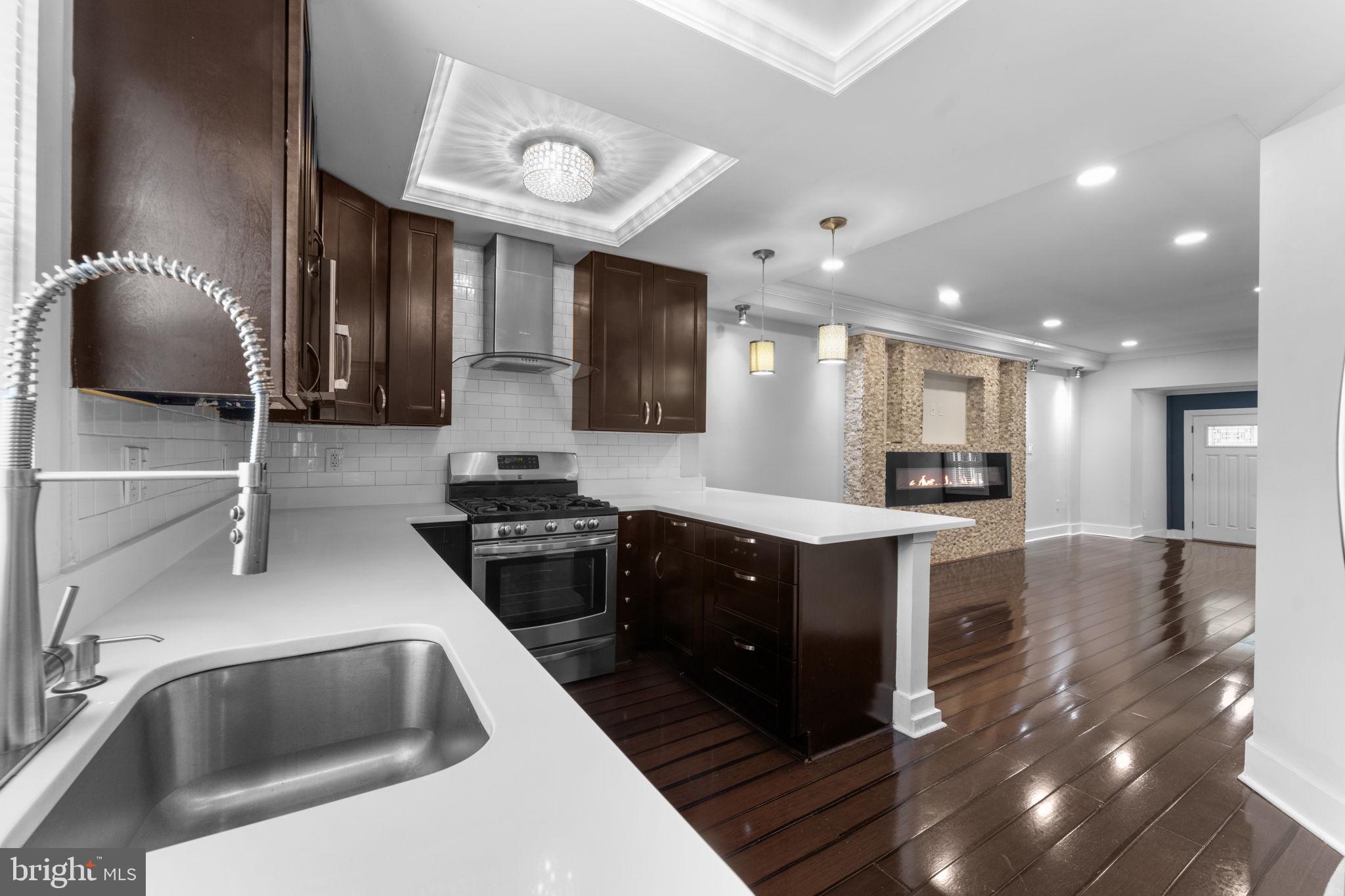 5209 5th Street Northwest Washington, DC 20011 - Photo 14 of 47 a kitchen with stainless steel appliances granite countertop a sink stove and refrigerator