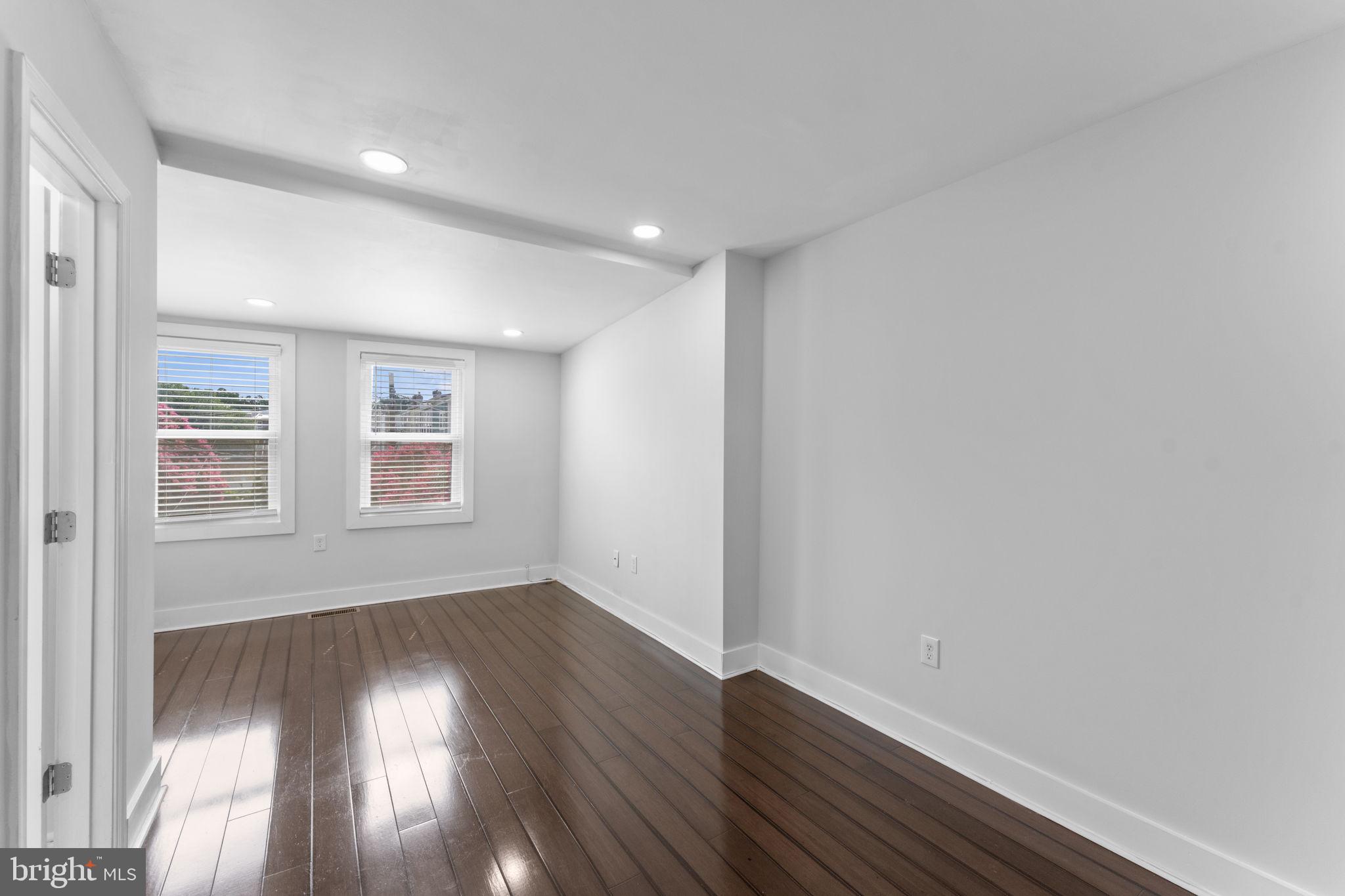 5209 5th Street Northwest Washington, DC 20011 - Photo 18 of 47 an empty room with wooden floor and windows