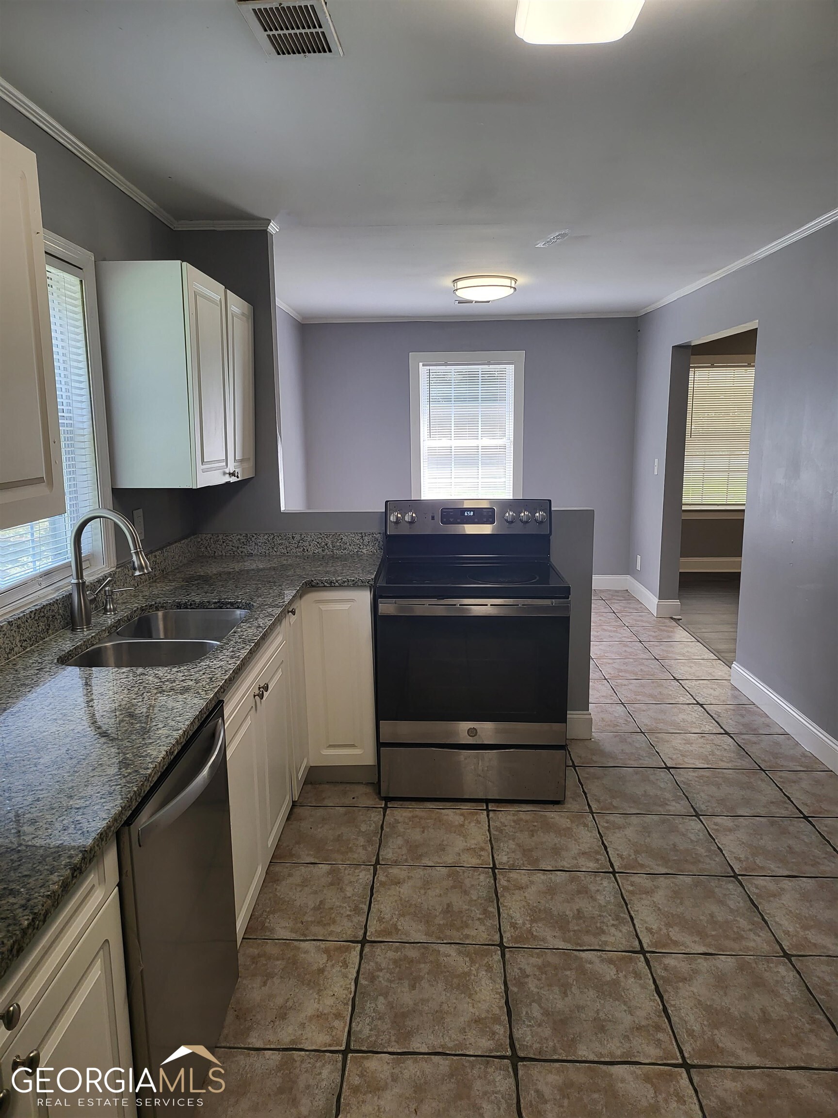 6819 Mark Turner Road Lithia Springs, GA 30122 - Photo 11 of 17 a kitchen with a sink and a stove top oven