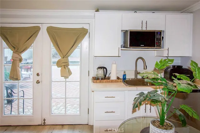 a kitchen with stainless steel appliances a stove a sink and a microwave