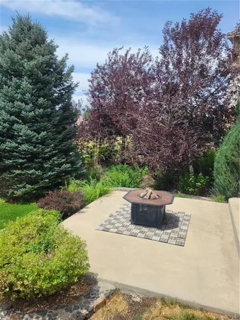 an aerial view of a house with a yard and potted plants