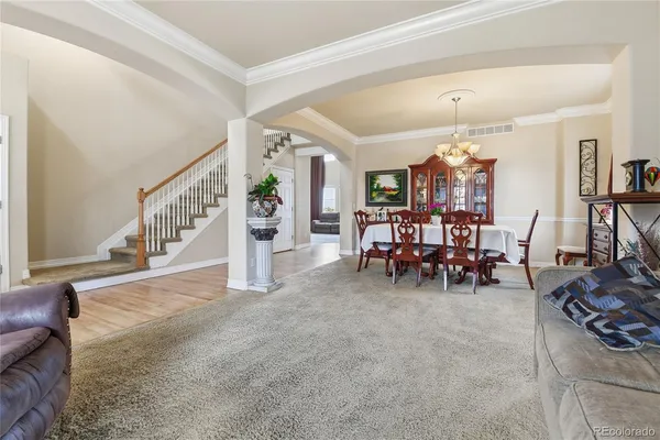 a living room with furniture and a chandelier