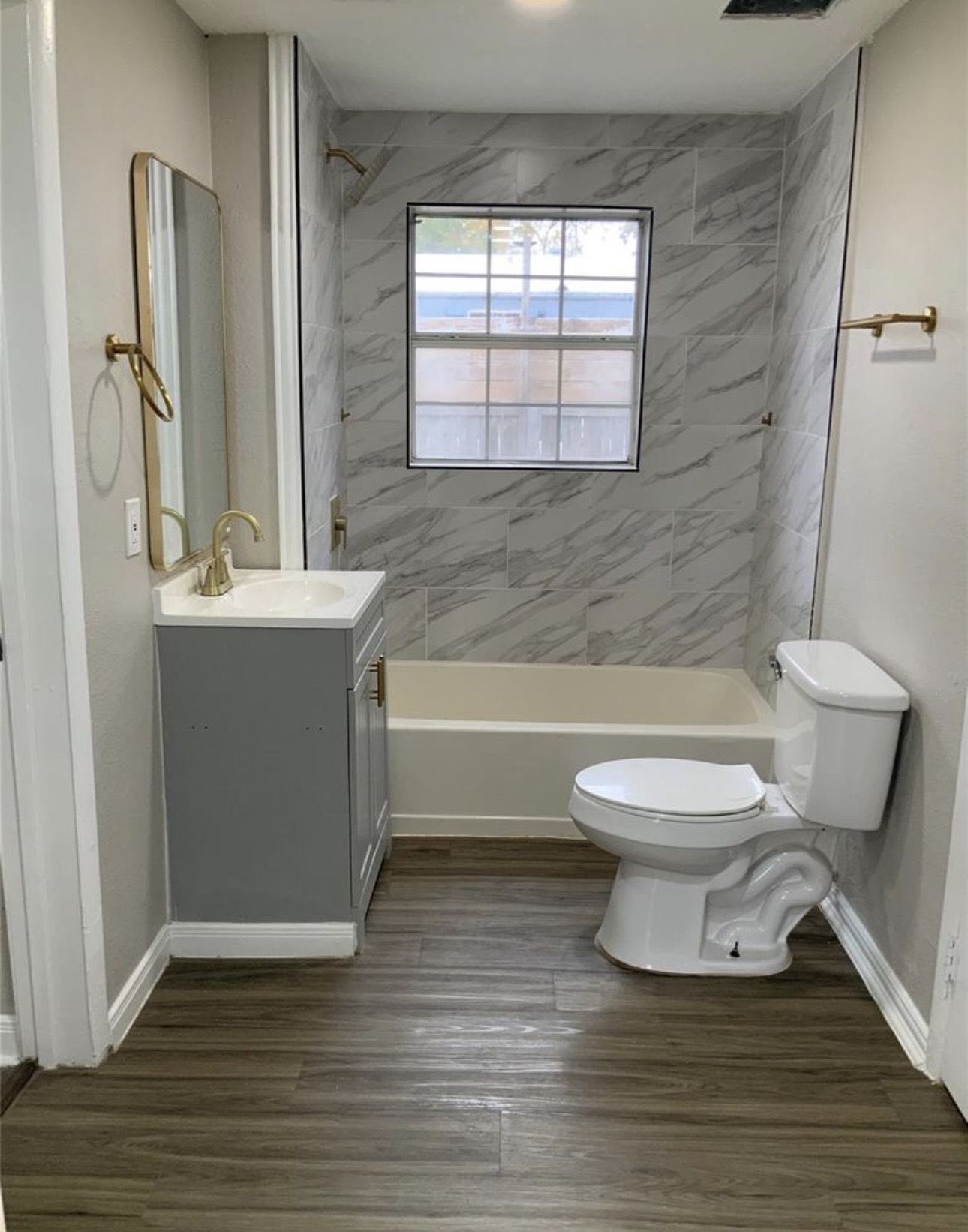 2415 Perry Street Baytown, TX 77521 - Photo 2 of 7 a bathroom with a toilet a sink and bathtub