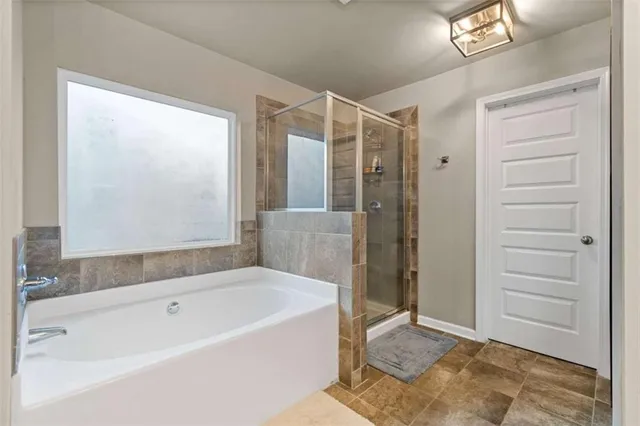 a bathroom with a bathtub and a shower
