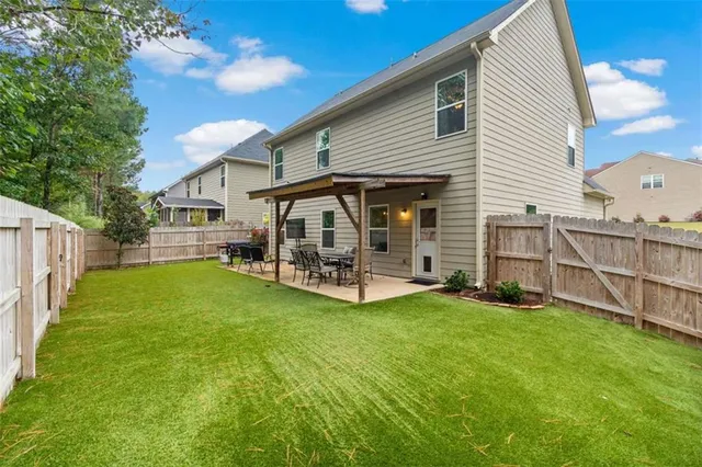 a view of a house with a yard and deck