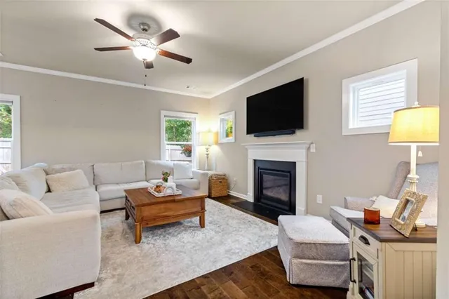 a living room with furniture a fireplace and a flat screen tv