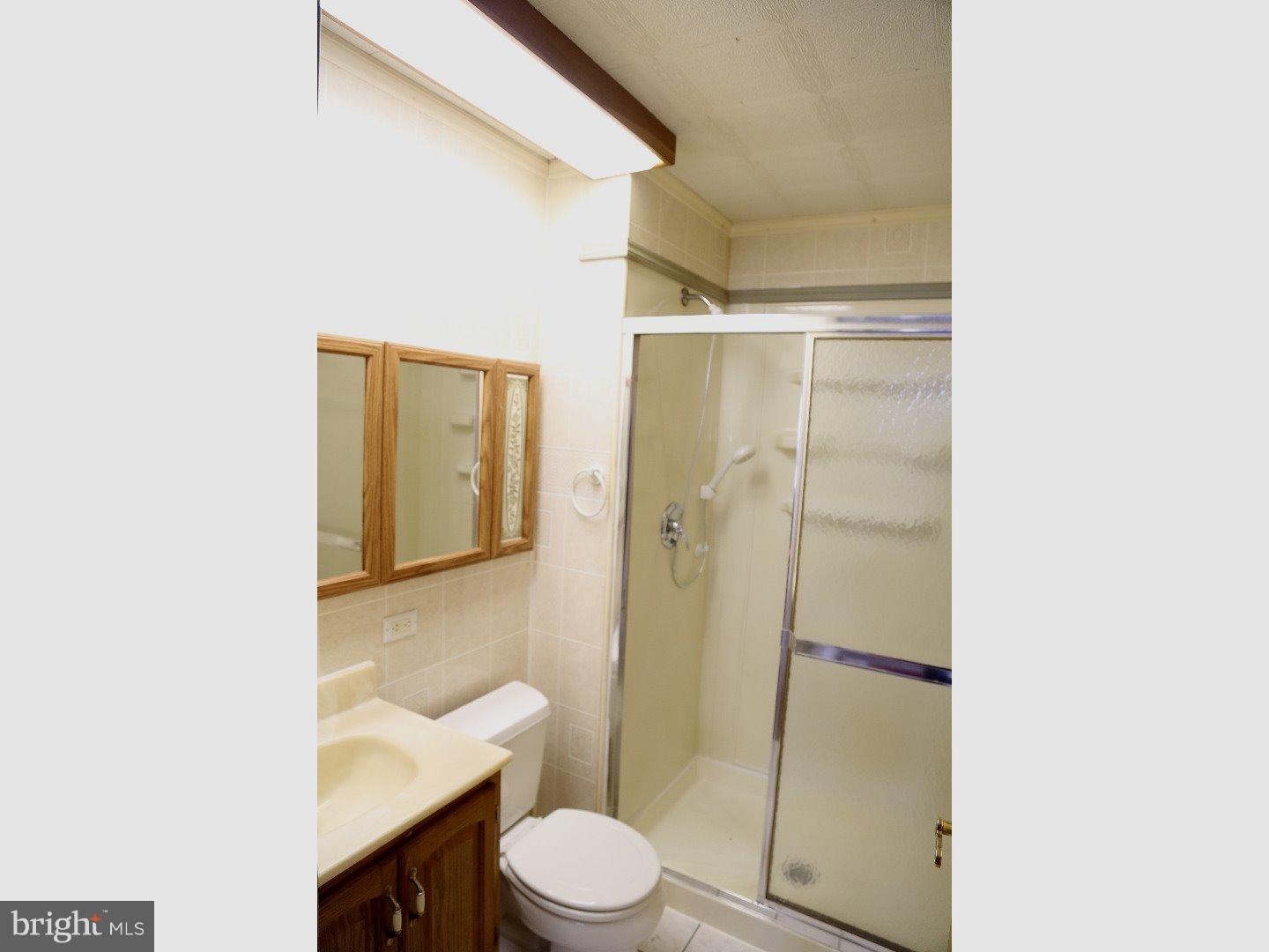 78 Candle Road Levittown, PA 19057 - Photo 14 of 23 a bathroom with a toilet a sink and shower