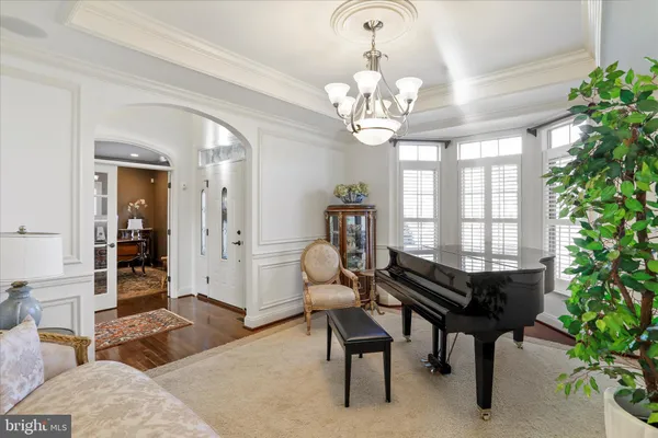 a kitchen with stainless steel appliances kitchen island granite countertop a refrigerator a sink dishwasher a stove with white cabinets and wooden floor