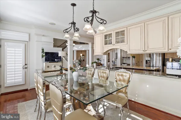 a living room with furniture a chandelier and a view of kitchen