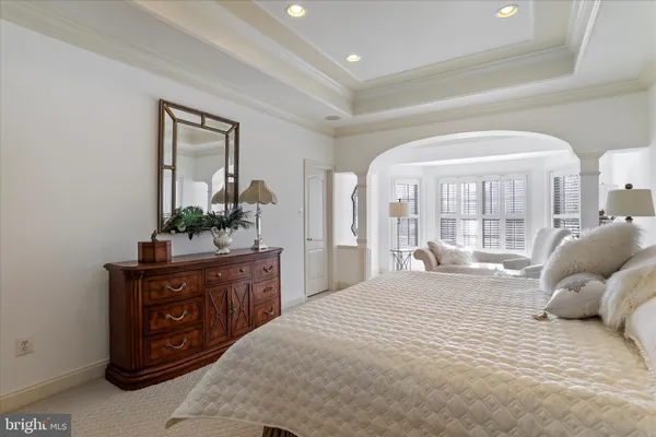 a dining room with furniture and a floor to ceiling window