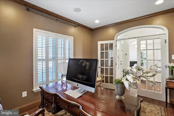 a kitchen with granite countertop a table chairs in it and wooden floors