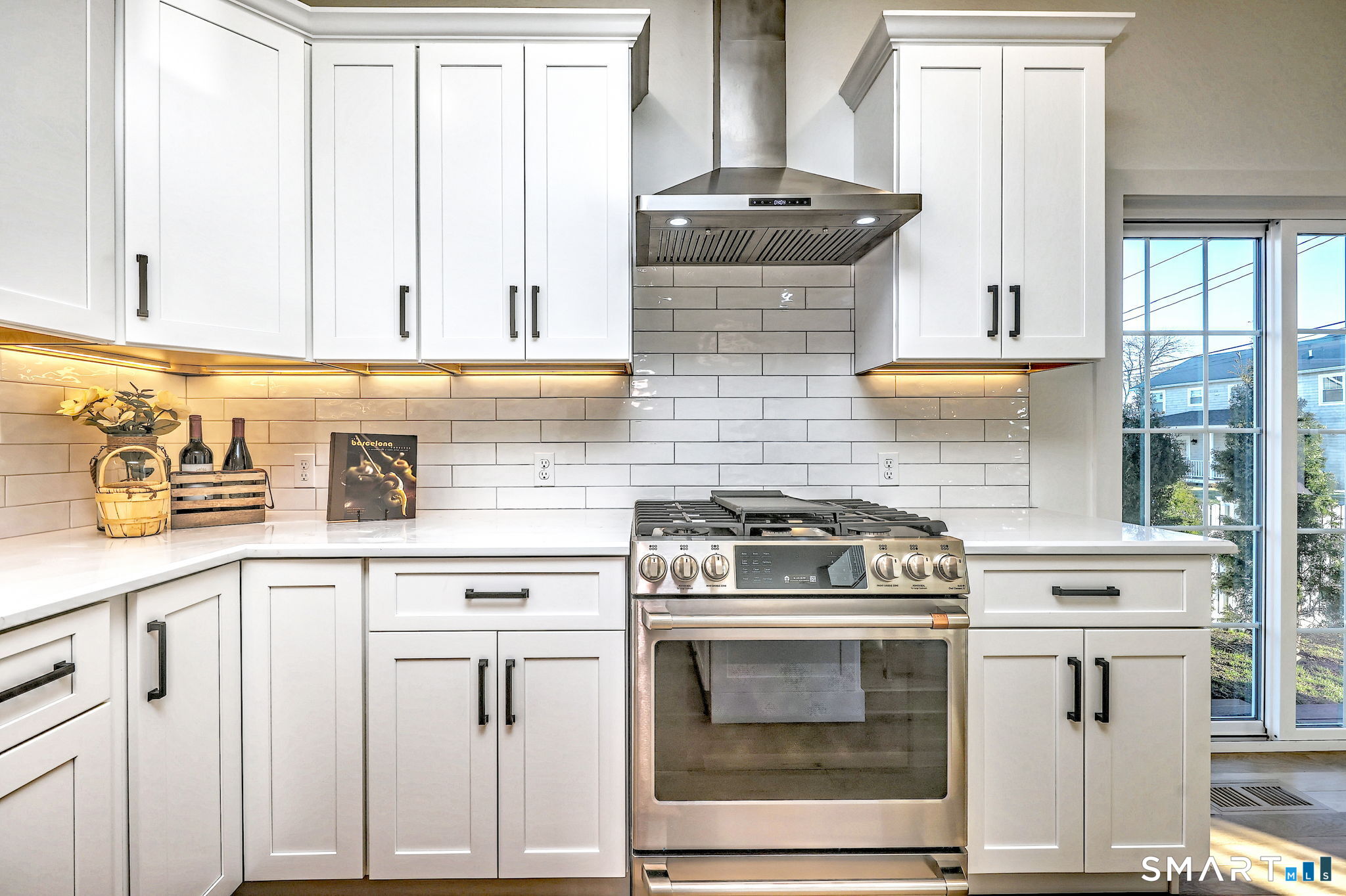 12 Usher Street Milford, CT 06460 - Photo 16 of 46 a kitchen with granite countertop white cabinets and white stove