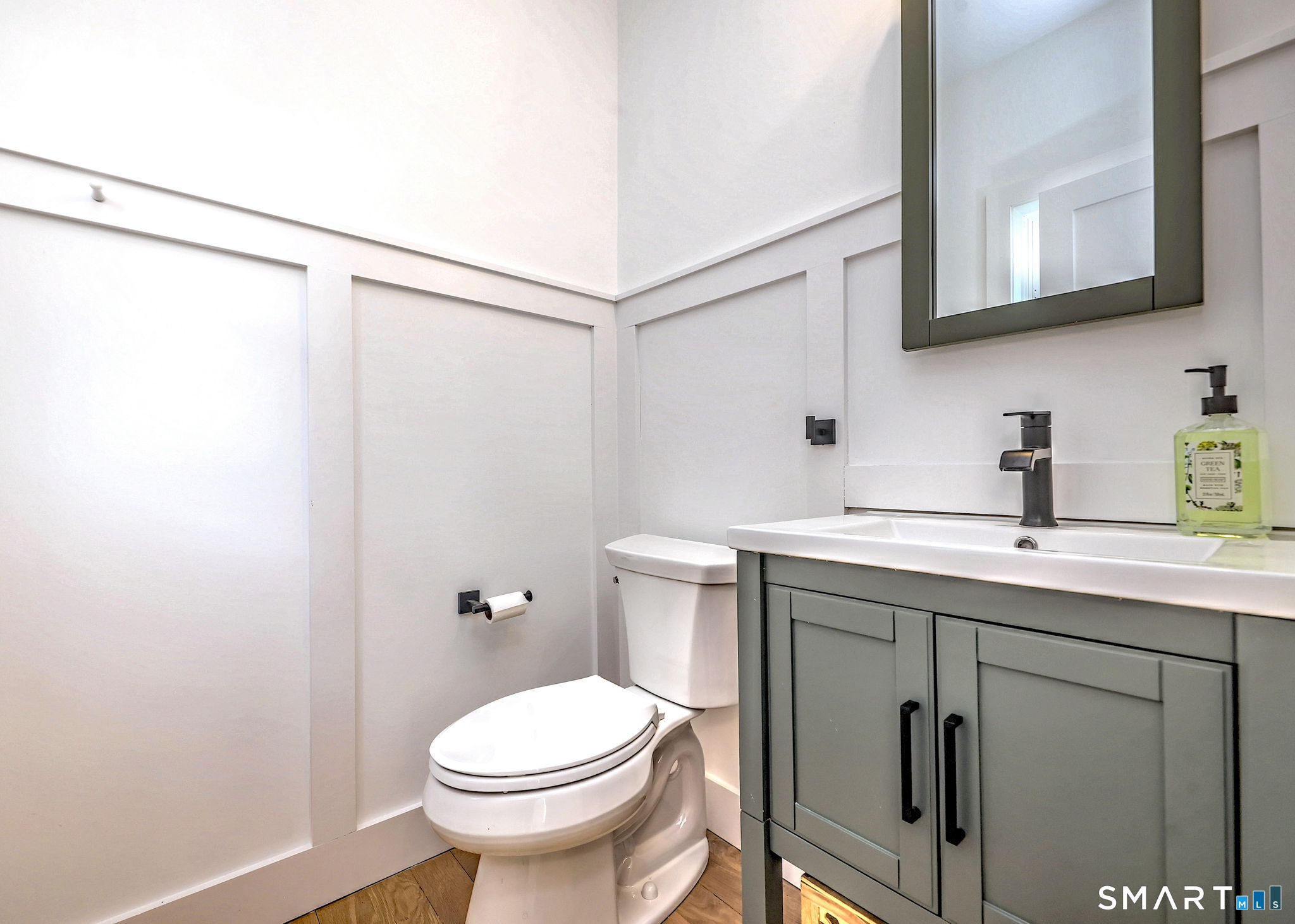 12 Usher Street Milford, CT 06460 - Photo 28 of 46 a bathroom with a sink a mirror and a toilet